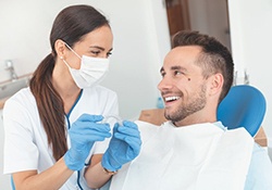 Downers Grove dentist showing patient his new Invisalign aligners