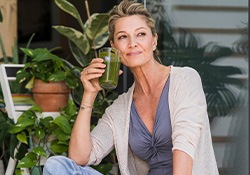 Middle-aged woman drinking a smoothie