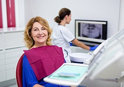woman in dental chair smiling toward the camera 
