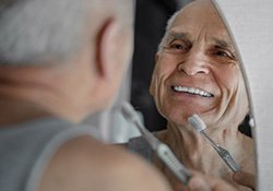 Older man brushing his teeth