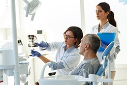 Patient in Downers Grove talking to dentist about dental bridges