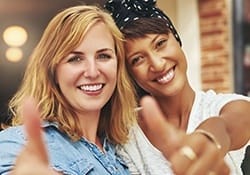 Two young women smiling together