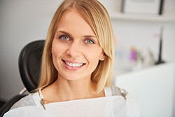 A pleased and smiling woman in a dentist’s clinic