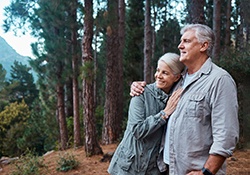 a mature woman with dentures smiling during a hike