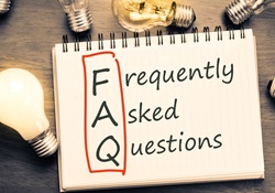 Lightbulbs and notepad that says Frequently Asked Questions