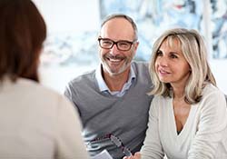 senior couple at a dental implant consultation