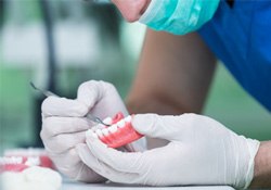 A lab worker creating dentures