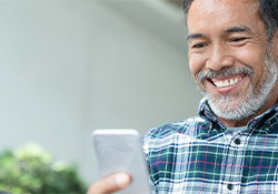 Man learning about dental implant care in Downers Grove