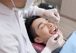 Implant dentist in Downers Grove performing a checkup