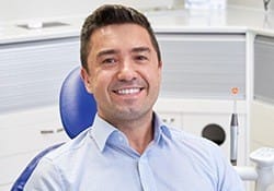 Smiling man in dental chair