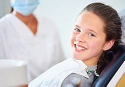 Smiling girl in dental chair