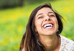 Young woman with bright happy smile outdoors