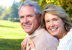 Older couple smiling together outdoors