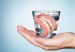 Full dentures in a glass of water
