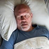 Man sleeping soundly in bed