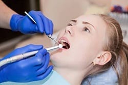 A dentist performing a dental checkup.