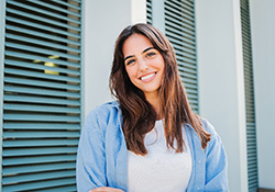 Woman with white teeth smiling outside