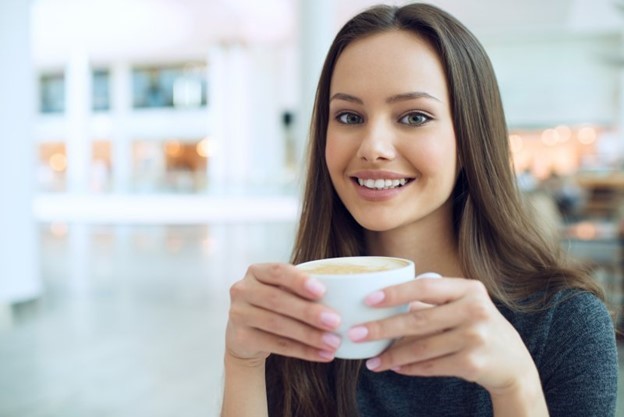 person sipping holiday drink